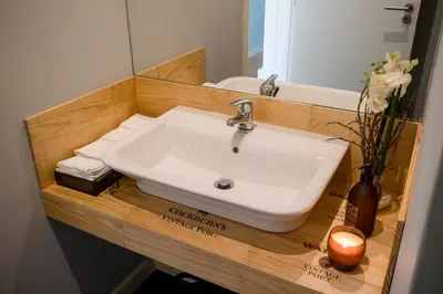 a bathroom with a sink and a mirror at Decanting Porto House in Porto