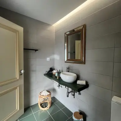 a living room with a chair and a window at Vila Camélia in Porto