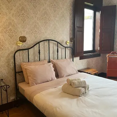 a room with a table and a room with a balcony at Vila Camélia in Porto