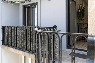 a balcony with a metal railing on a building at Lovely Flat Marquês in Porto