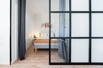 a bedroom with a bed and sliding glass doors at Catarina's Little Corner by LovelyStay in Porto