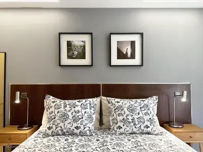 a bedroom with a bed with two pictures on the wall at ROSARIO 1E by rosario inn porto in Porto