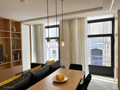 a living room with a table and a couch at ROSARIO 1E by rosario inn porto in Porto