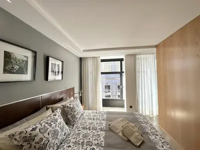 a bedroom with a bed and a large window at ROSARIO 1E by rosario inn porto in Porto