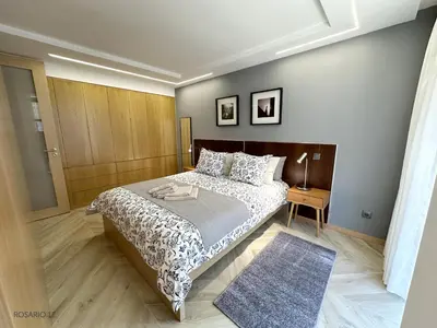 a bedroom with a bed and a table with a rug at ROSARIO 1E by rosario inn porto in Porto
