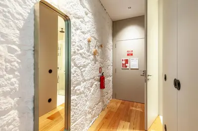 a hallway with a large mirror and a door at Perfect retreat in the center of Porto in Porto