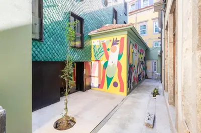 a building with a mural on the side of it at Perfect retreat in the center of Porto in Porto