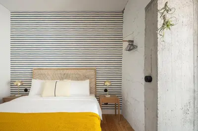 a bedroom with a bed with a yellow blanket at Elegant apartment in the historical center of Porto in Porto