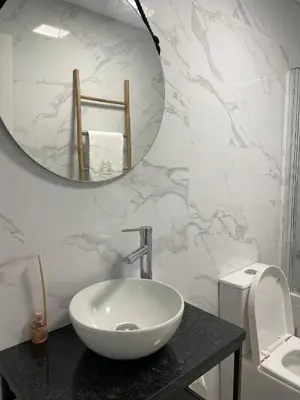 a bathroom with a white sink and a mirror at Marinho's Oporto Apartments II in Porto