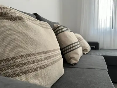 two pillows on a couch in a living room at Marinho's Oporto Apartments II in Porto