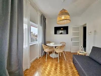 a kitchen with a sink and a counter with two chairs at LM art apartments in Porto