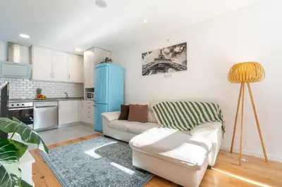 a living room with a couch and a blue refrigerator at Host Wise - Elegant Colorful House w Private Terrace in Porto