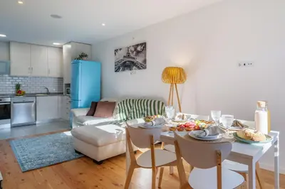 a kitchen and living room with a table with food on it at Host Wise - Elegant Colorful House w Private Terrace in Porto