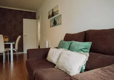 a living room with a couch with pillows on it at D João IV Stay in Porto