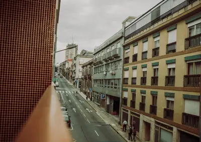 a view of a city street with buildings at D João IV Stay in Porto