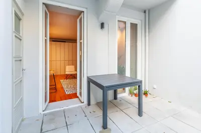 a black table sitting on the floor of a hallway at Sta. Catarina 618 Suite in Porto