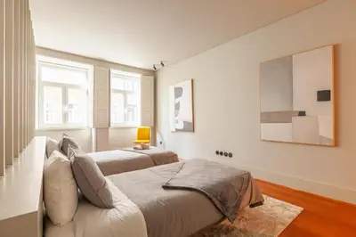 a bedroom with two beds and a picture on the wall at Sta. Catarina 618 Suite in Porto