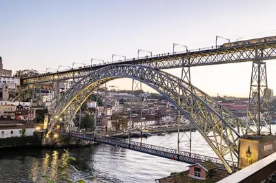 a bridge over a river with a city at Panoramic River View Downtown With Terrace in Porto