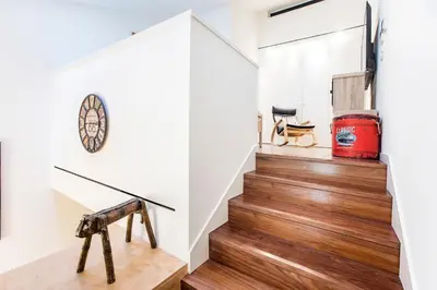 a staircase in a house with wood flooring and a stair case at GuestReady - Super cozy 1BDR apartment for 4pax in Porto