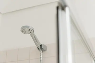 a shower with a shower head in a bathroom at GuestReady - Arcos da Ribeira in Porto