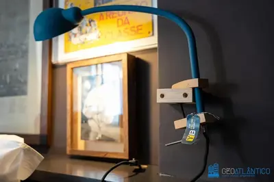 a blue lamp sitting on top of a desk at Y Trendy Arthouse Boavista in Porto