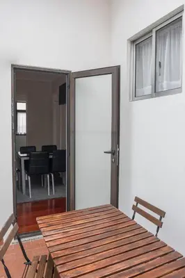 a room with a table and a sliding door with a dining room at Apartamentos Portodouro - Ribeira in Porto