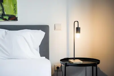a bedroom with a bed and a table with a lamp at GuestReady - Sunny Stay in Porto City Center in Porto