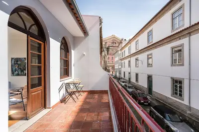 a balcony with a wooden door and some buildings at GuestReady - Sunny Stay in Porto City Center in Porto