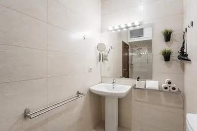a white bathroom with a sink and a mirror at GuestReady - Sunny Stay in Porto City Center in Porto