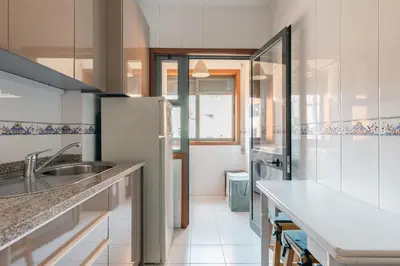 a kitchen with a sink and a refrigerator at Lázaro 2 Bedroom Apartment in Porto