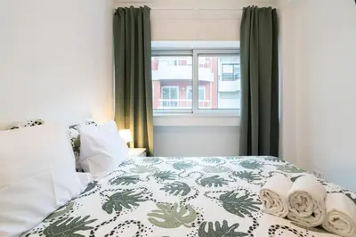 a bedroom with a bed and a window at Moreira Family in Porto