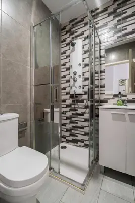 a bathroom with a toilet and a glass shower at Moreira Family in Porto