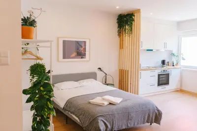 a bedroom with a bed with two towels on it at Porto serenity studio in Porto