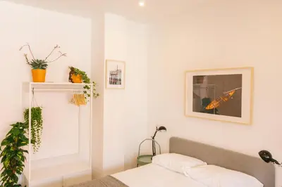 a bedroom with white walls and a bed at Porto serenity studio in Porto