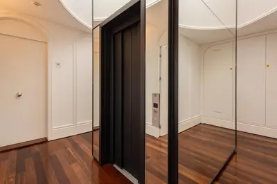 a mirror in a room with wood floors and white walls at Clerigos 82 luxury Housing in Porto