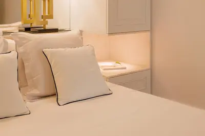a white bed with white pillows and a table at Clerigos 82 luxury Housing in Porto