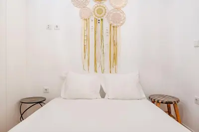 a white bed with two pillows on top of it at VIVA Bonfim Cozy Home in Porto