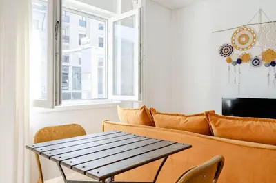 a living room with a couch and a table at VIVA Bonfim Cozy Home in Porto