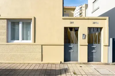 a building with two doors on the side of it at VIVA Bonfim Cozy Home in Porto