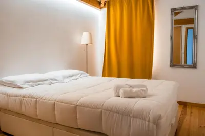 a bedroom with a bed with two towels on it at Casa do Vasco in Porto
