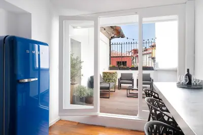 a kitchen with a door open to a balcony at Historical Penthouse at Cardosas Block in Porto
