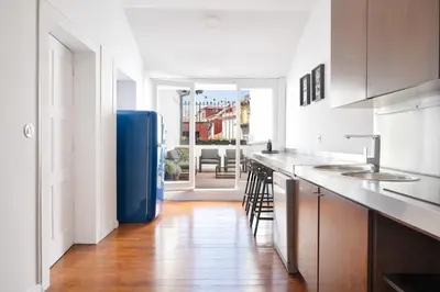 a kitchen with a blue refrigerator in a room at Historical Penthouse at Cardosas Block in Porto