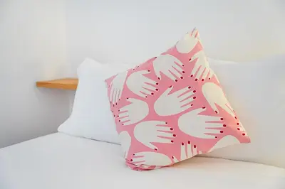 a pink and white pillow on a bed at Panorama Apartments Porto Poveiros in Porto