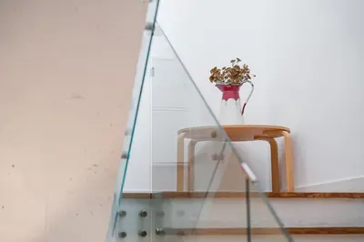 a vase with a plant on a glass table at Panorama Apartments Porto Poveiros in Porto