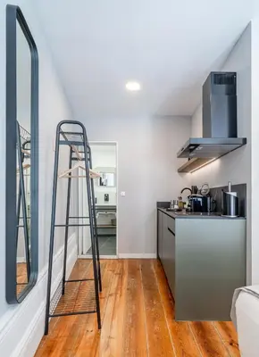 a kitchen with a ladder in a kitchen with a counter at Limehome Porto Rua de Dom Manuel II in Porto