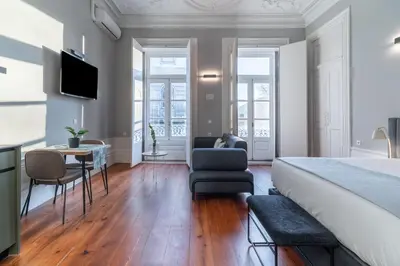 a bedroom with a bed and a living room at Limehome Porto Rua de Dom Manuel II in Porto