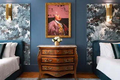 a bedroom with two beds and a painting on the wall at Cardosas Gem - Historic ap 1F in Porto
