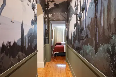 a hallway with a painting on the wall and a bedroom at Cardosas Gem - Historic ap 1F in Porto