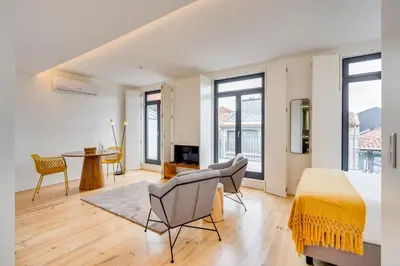 a living room with a bed and a table at Alma da Casa by DA'HOME in Porto
