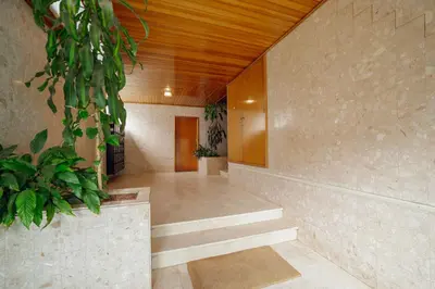 a hallway with stairs and plants in a building at Pateo In Lapa City Center by Vacationy in Porto